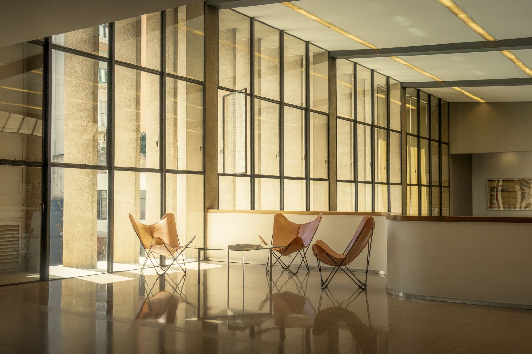 Modern office lounge with glass walls and seating