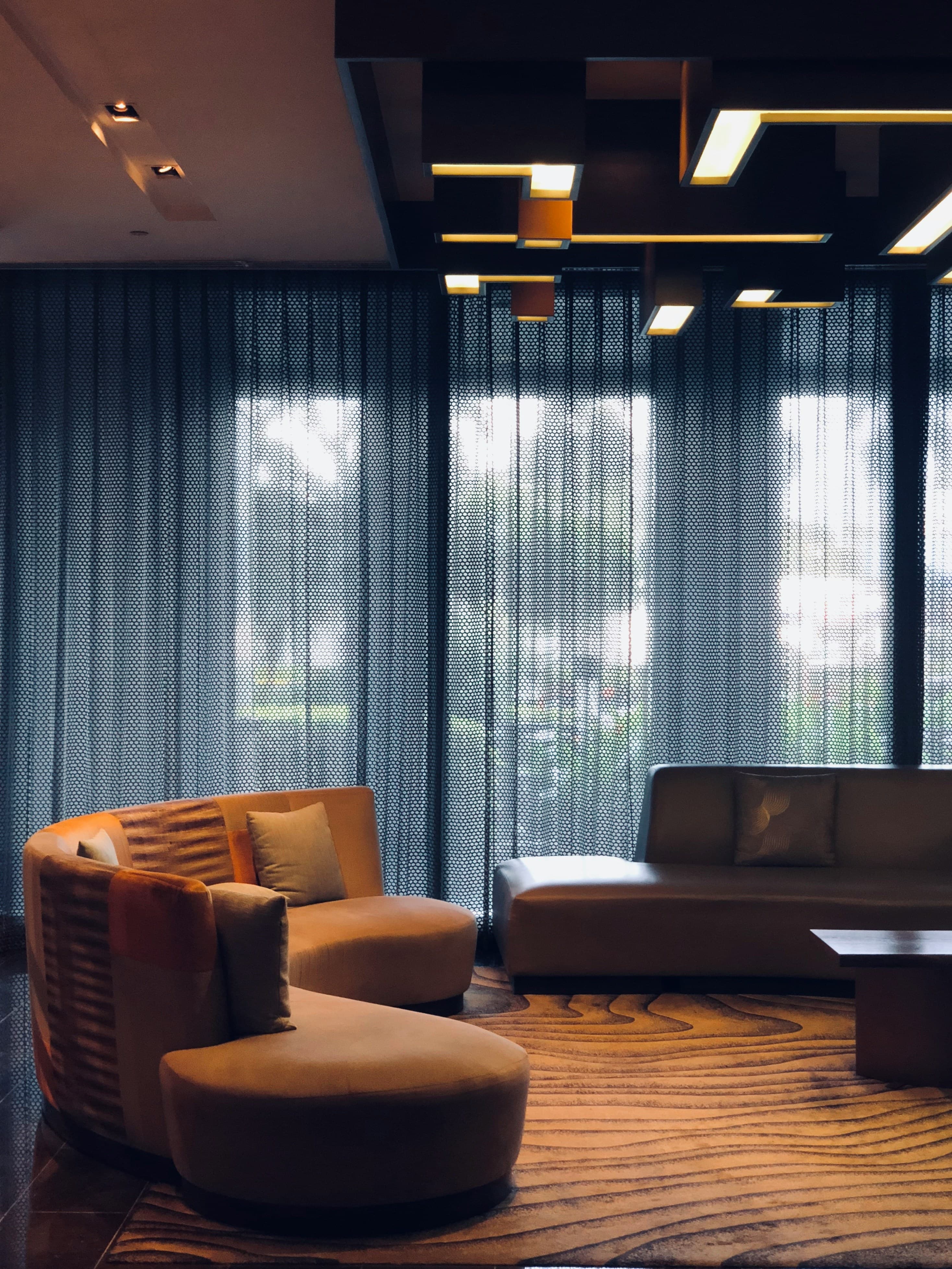 An amber-toned lounge with sculptural armchairs