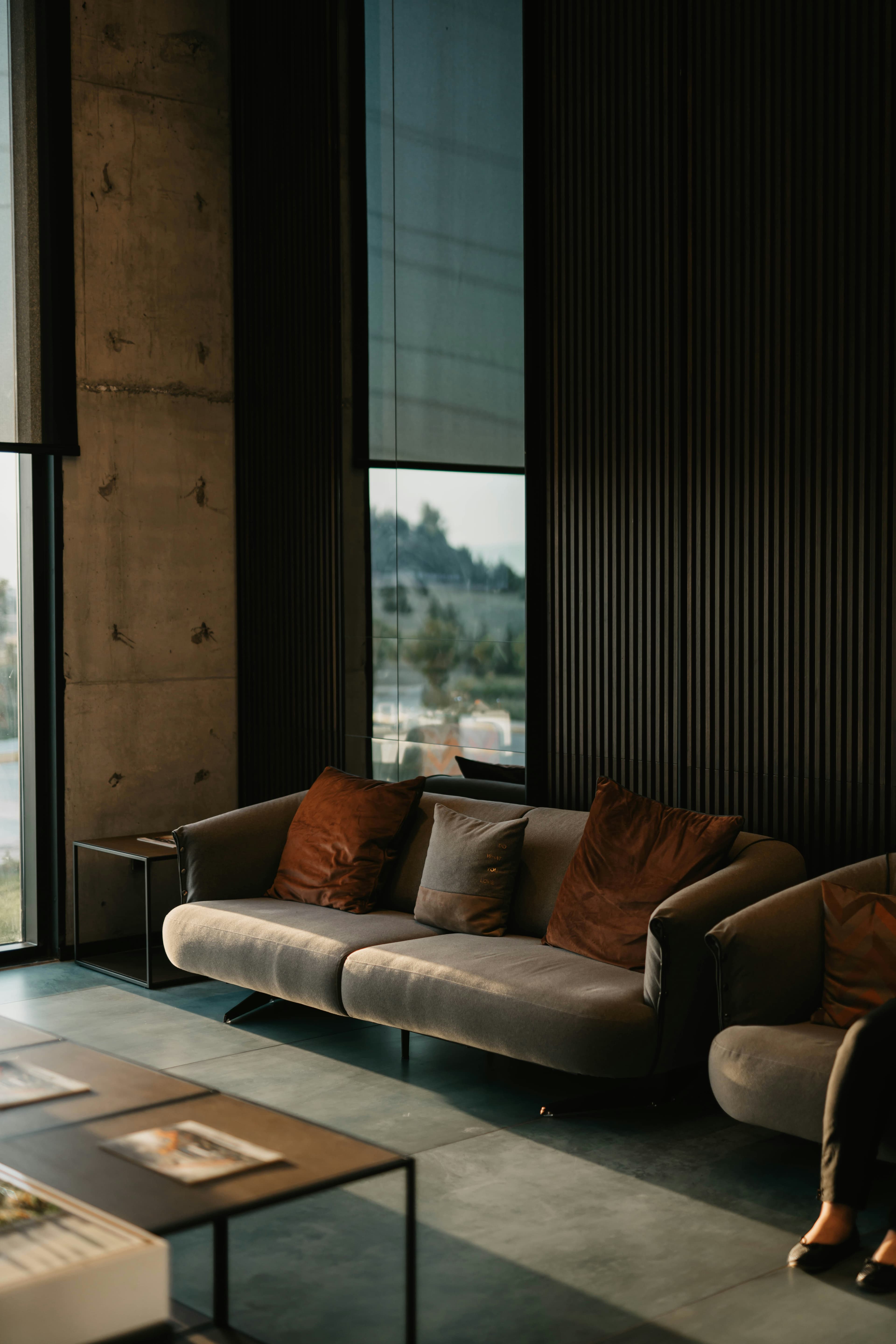 A dark, tailored lounge with a low sofa