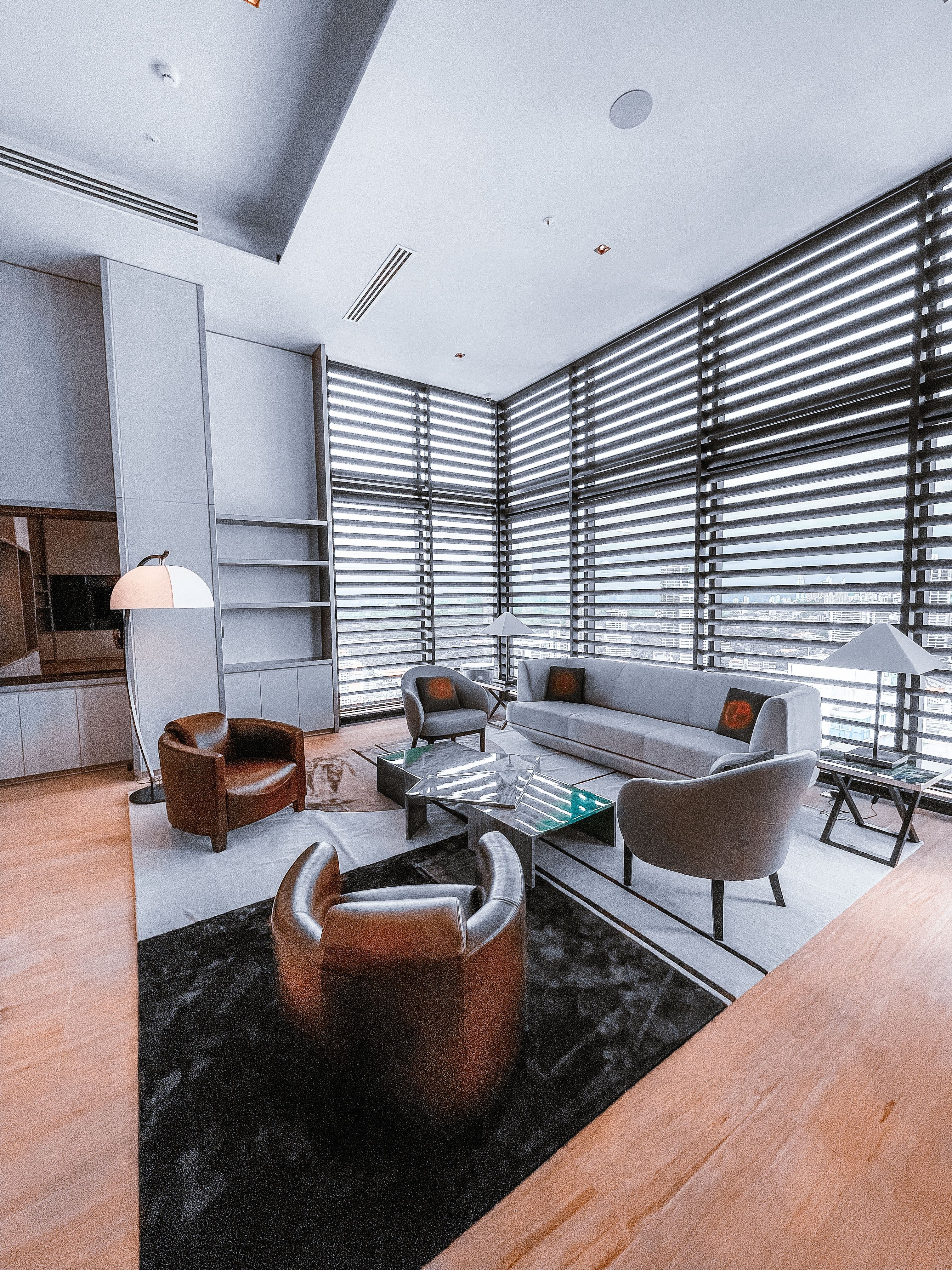A refined lounge with a sofa and wall-to-wall windows
